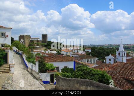 Panoramic village scene with the castle and Santa Maria church, Obidos, Portugal Stock Photo