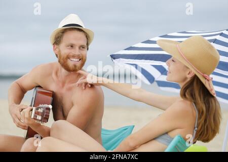 man plays guitar on the beach Stock Photo