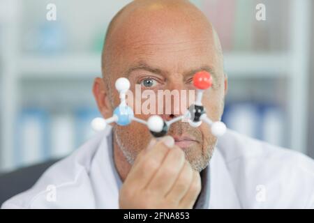 handsome scientist making research over dna molecule structure Stock Photo