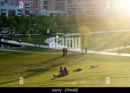 Russia, Moscow - 15 May 2021: Khodynka field, Park and residential area. People relax in the city Park at sunset on a hot day. High quality photo Stock Photo