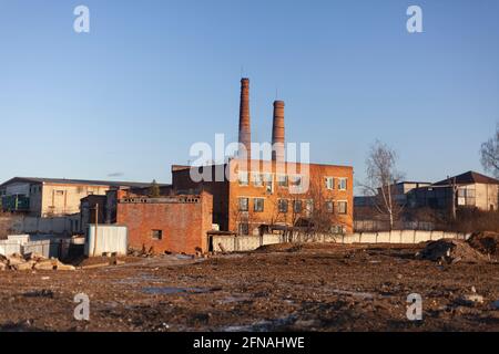 Factory pipes. Brick factory. Industrial area outside the city. Industrial landscape. Red brick building. An ancient building. Stock Photo