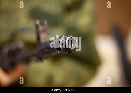 The barrel of an assault rifle. The weapon in the hands. Firearms in combat condition. Kalashnikov assault rifle. Training soldiers. Military subjects Stock Photo