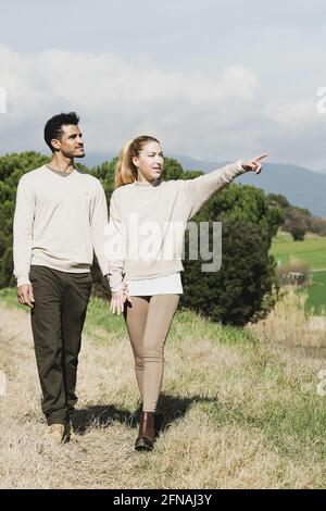 Happy young couple walking through the countryside Stock Photo