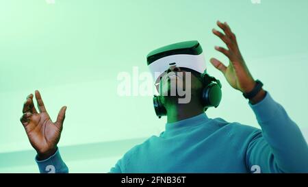 Man wearing Virtual Reality glasses and enjoying the 360 Degree virtual environment. High quality photo Stock Photo