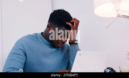 Stressed out man working on his laptop. Work stress or work load concept. High quality photo Stock Photo
