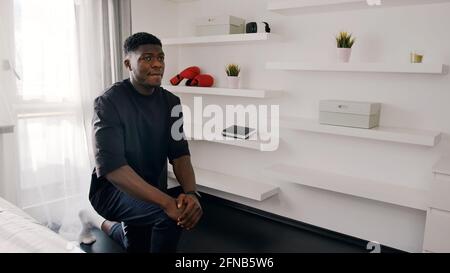 African American guy dressed black shirt warming up in front of a camera. High quality photo Stock Photo