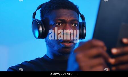 African american black man with headset playing games on tablet. High quality photo Stock Photo
