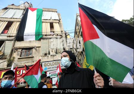 Beirut, Lebanon. 15th May, 2021. People hold Palestinian flags during a demonstration to express solidarity with the Palestinian people in Beirut, Lebanon, on May 15, 2021. Credit: Bilal Jawich/Xinhua/Alamy Live News Stock Photo