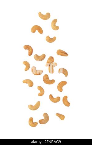 Cashew nuts falling isolated on white background with clipping path. Stock Photo