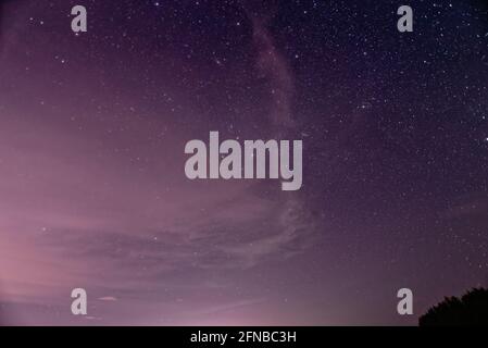 Purple night sky full of stars as background
