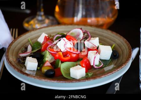 Salad of cheese, paprika, onions, olives on a banquet table in a restaurant. Stock Photo