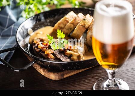 Czech beef, sauce and dumplings food svickova served along with a draft beer. Stock Photo