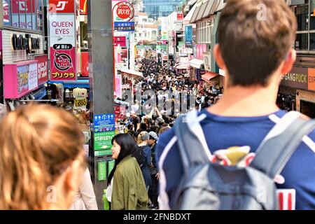Takeshita Street in Harajuku, Tokyo is crowded with shoppers and lined with boutiques, cafes and restaurants Stock Photo
