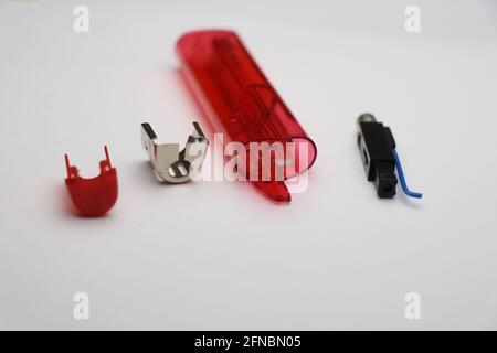Disassembled fire lighter with piezo ignition part, cap and tank isolated on white background Stock Photo