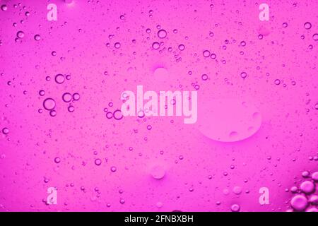 close-up view of a soft pink liquid background of moving bubbles Stock Photo