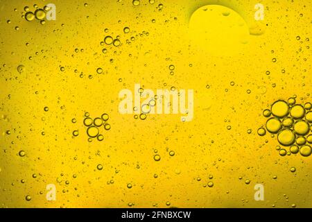 close-up view of a yellow liquid background of moving bubbles Stock Photo