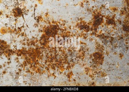 Close up of rust and corrosion forming on zinc plated steel sheet. Mineralisation. Compositing texture, grunge, rust, weathering, aged, vintage. Backg Stock Photo