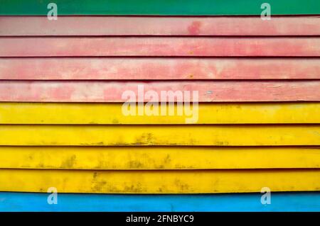 Colourful textured background of colourful, distressed horizontal wooden slats. Stock Photo