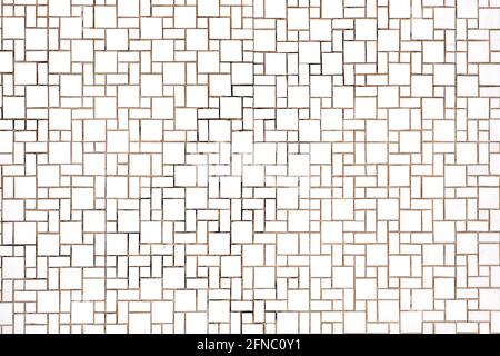 Background from a wall made of rectangular and square white mosaic tiles Stock Photo