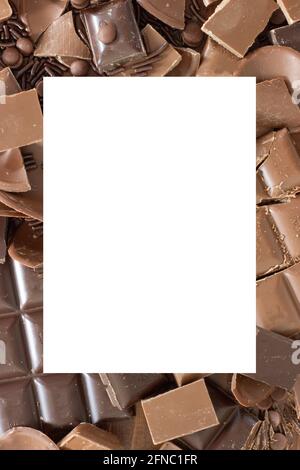 White frame surrounded bay different kinds of chocolates; background with copy space Stock Photo
