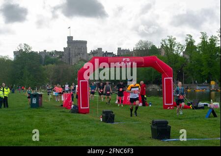 Windsor, Berkshire, UK. 16th May, 2021. Approximately 700 runners entered The Royal Windsor Half Marathon River Trail today. Runners starting on the Brocas in Eton before their run along the banks of the River Thames. The runners were all socially distanced and could not start the race until they were called forward individually. The runners were delighted to be back out doing competitions again following the lifting of some of the Covid-19 Coronavirus lockdown restrictions. Credit: Maureen McLean/Alamy Live News Stock Photo