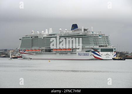 Southampton UK 16th May 2021. P&O Cruises latest edition to the fleet Iona arrives in Southampton in heavy rain ahead of her naming ceremony today (16-05-21) by the Ships Godmother Dame Irene Hays in a virtual ceremony that will include a live performance from singer Gary Barlow and hosted by DJ and Broadcaster Jo Whiley. Dame Hays founded Hays Travel in 1980 with her husband John who died suddenly in November 2020. P&O's Iona is the largest cruise ship built for the UK market and can hold 5200 passengers and 1800 crew, she is 344m in length. She also is the first British cruise ship to be pow Stock Photo