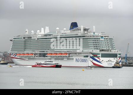 Southampton UK 16th May 2021. P&O Cruises latest edition to the fleet Iona arrives in Southampton in heavy rain ahead of her naming ceremony today (16-05-21) by the Ships Godmother Dame Irene Hays in a virtual ceremony that will include a live performance from singer Gary Barlow and hosted by DJ and Broadcaster Jo Whiley. Dame Hays founded Hays Travel in 1980 with her husband John who died suddenly in November 2020. P&O's Iona is the largest cruise ship built for the UK market and can hold 5200 passengers and 1800 crew, she is 344m in length. She also is the first British cruise ship to be pow Stock Photo