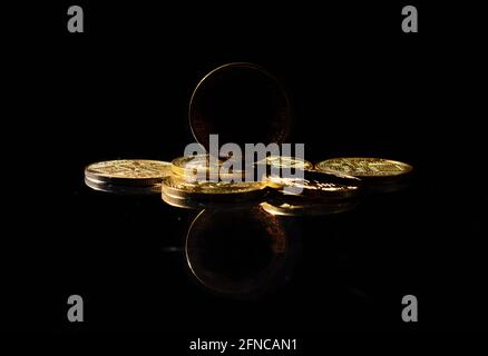 Dark altcoin on market. Independent stablecoin. New cryptocurrency on a top of coins against black mirror surface. Black crypto token. Noname or Stock Photo
