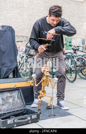A Street Entertainer with a skeleton in Salzburg, Austria Stock Photo
