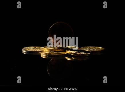 Dark altcoin on market. Independent stablecoin. New cryptocurrency on a top of coins against black mirror surface. Black crypto token. Noname or Stock Photo