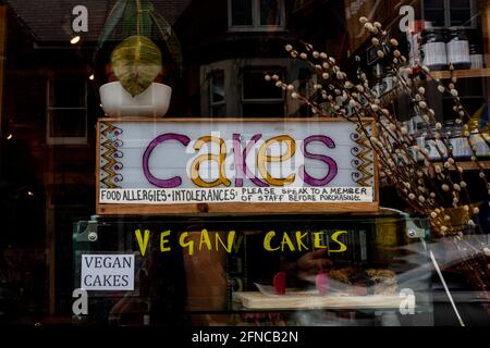 A display of vegan cakes in Arjuna health shop on Mill Road, Cambridge, UK. Stock Photo