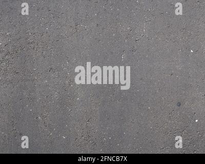 Dark gray rough asphalt surface. Full screen photo. Stock Photo