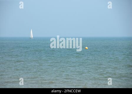 Lone sailing yacht in the sea off the south coast of England Stock Photo