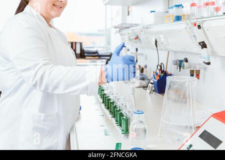 Woman doctor using dropper in lab Stock Photo