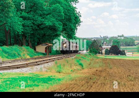 Strasburg, PA, USA - May 15, 2021: A steam locomotive from the Strasburg Rail Road stops at a picnic grove in rural Lancaster County, PA. Stock Photo