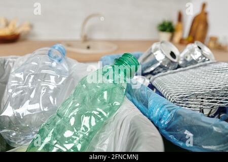 Trash bins with empty cans, plastic bottles and other waste in home environment Stock Photo