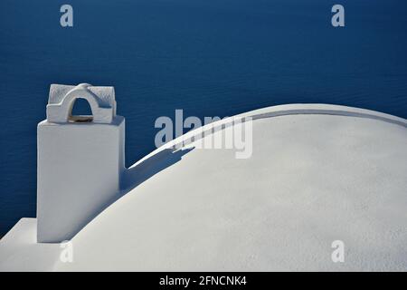 Traditional Cycladic architecture chimney on an adobe house rooftop in Santorini island, Cyclades Greece. Stock Photo