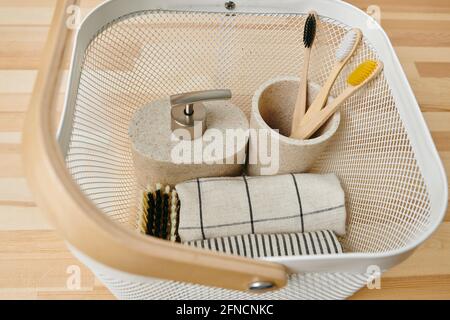 A basket with a variety of bodycare items in it on wooden table or shelf Stock Photo