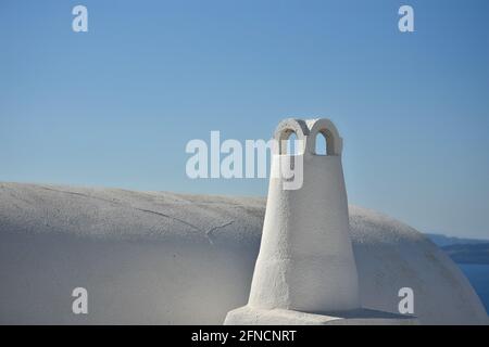 Traditional Cycladic architecture chimney on an adobe house rooftop in Santorini island, Cyclades Greece. Stock Photo