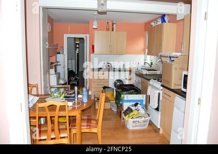 kitchen in Student accommodation reading UK with laundry fire blanket also table and chairs pots pans sink cooker chairs chair table cupboards Stock Photo