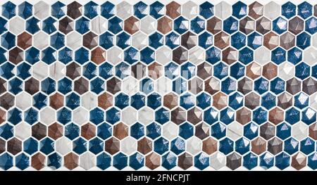 The texture of the panel of blue brown, beige and white shades of stone mosaic. Polished stone surface. Stock Photo