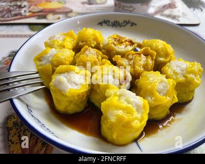 Famous dim sum, Siu Mai. Chinese steamed pork dumplings. Cooking at home. Stock Photo