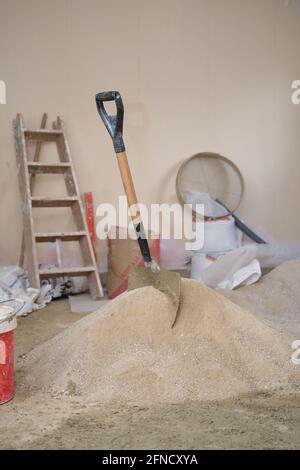 Construction site. Shovel on a pile of sand and cement. Stock Photo
