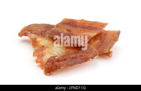 Several pieces of salted fish with red pepper isolated on white. Stock Photo