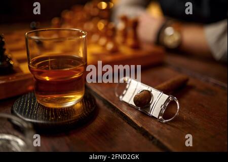 Cigar in ashtray, alcohol, lighter and guillotine Stock Photo
