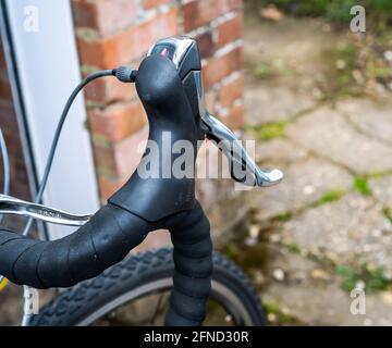 Close and selective focus on the drop handle bars, brake lever and gear shifter of a road racing bicycle. Stock Photo