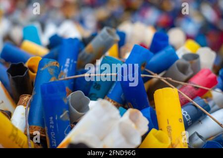 Many colorful spent shotgun shells displayed in front of a shooting range in the UK. Many different colors and gauges, concepts of clay shooting, war, Stock Photo