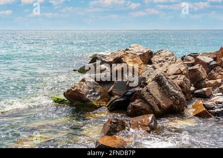 breakwater of large stones on the beach Stock Photo