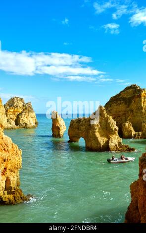 Tourists enjoying the view of the spectacular rock formations from a boat Stock Photo