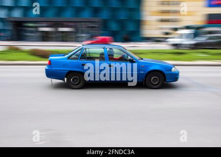 Ukraine, Kyiv - 26 April 2021: Blue Daewoo Nexia car moving on the street. Editorial Stock Photo